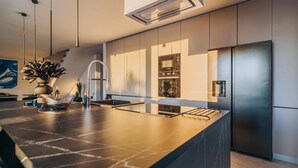 A modern kitchen with a central island, stainless steel appliances, and a sleek design. - Beautiful home in Privlaka with sauna (Privlaka)