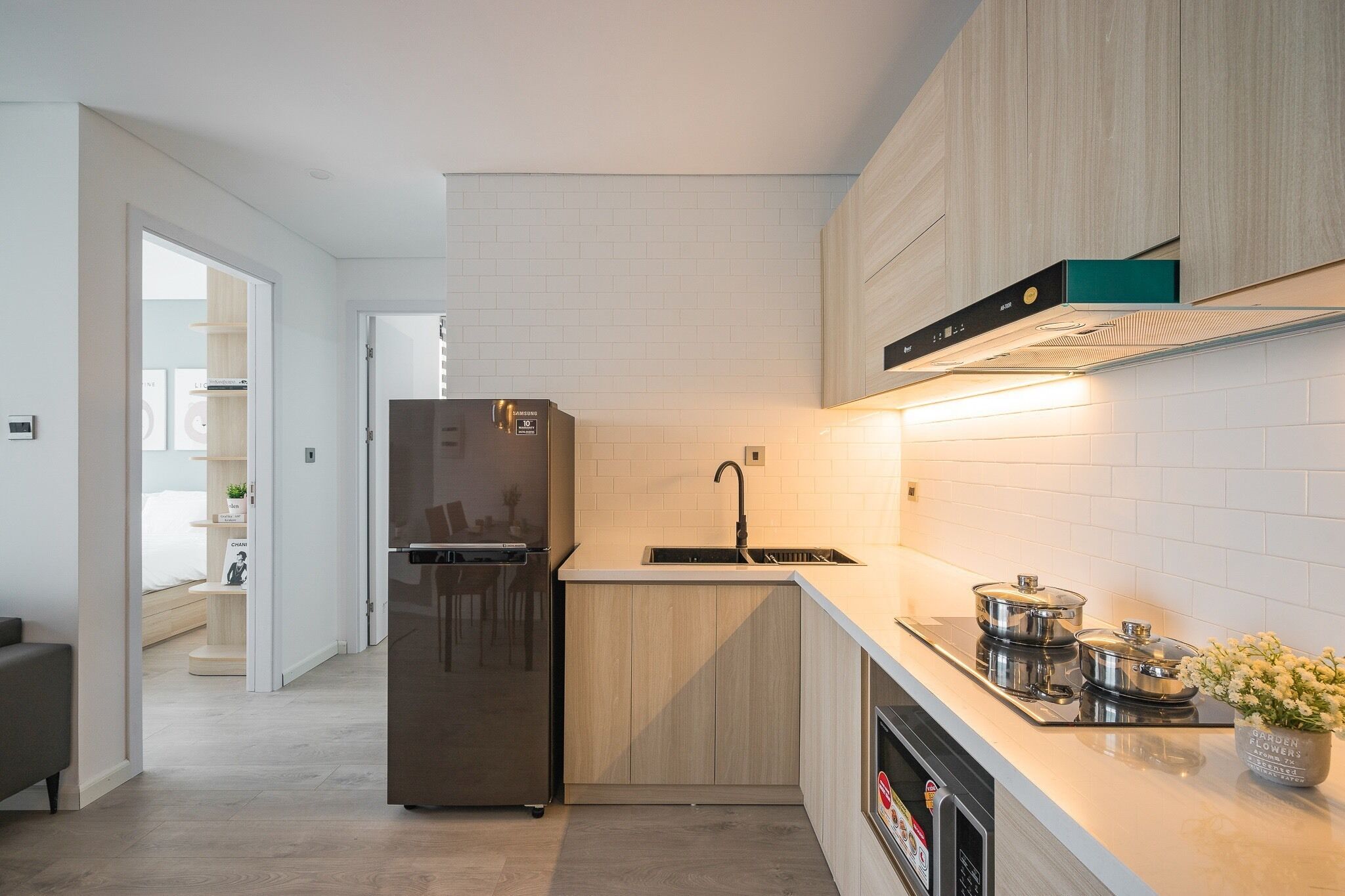 A modern kitchen with a built-in refrigerator, a sink, and a stove.