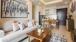 A modern living room with a sofa, coffee table, and dining area.