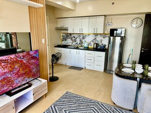Departamento Confort, vista parcial al océano | Área de sala de estar | Televisión LCD de 55 pulgadas con canales digitales y Netflix 