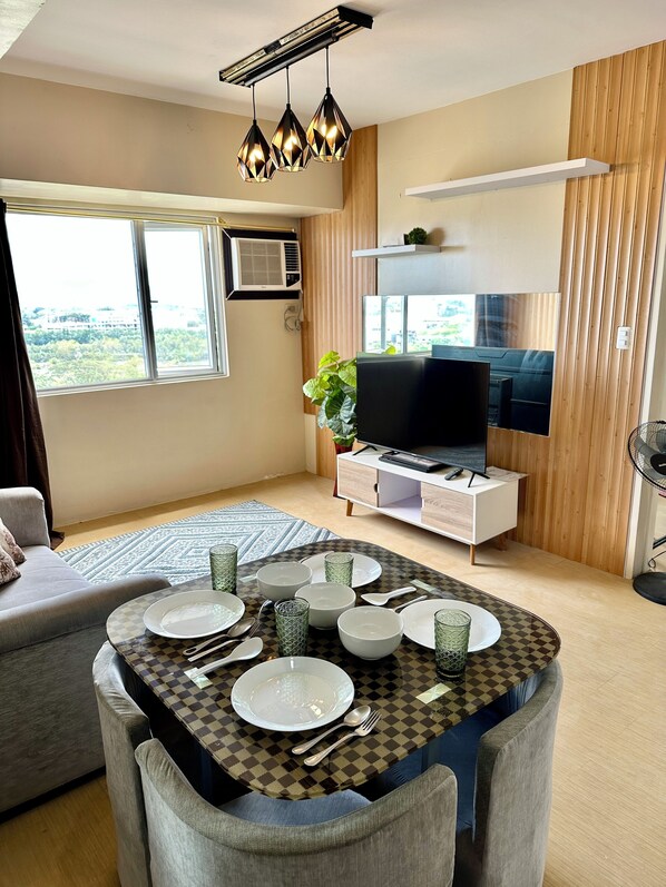 Comfort Apartment, Partial Ocean View | Living area | 55-inch LCD TV with digital channels, Netflix, streaming services - Wonderful One Bedroom at Avida No. 40 (Iloilo)