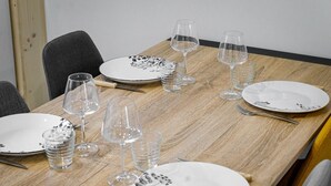 A dining table set with plates, glasses, and cutlery.