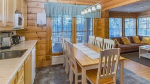 A wooden cabin interior with a kitchen, dining area, and living room. - Alakoski by Interhome (Inari)