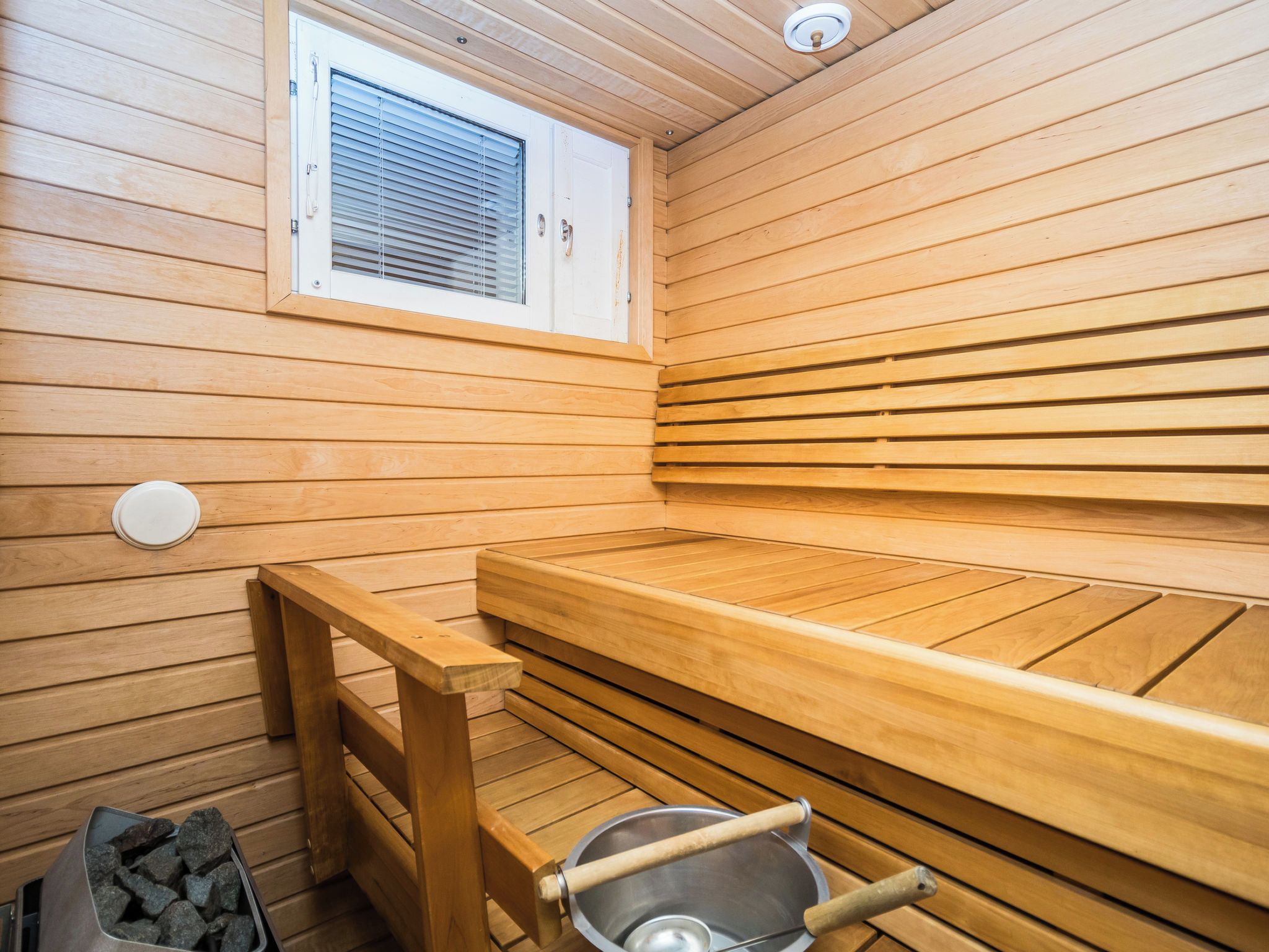 A sauna with wooden benches and a window.