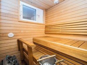 A sauna with wooden benches and a window. - Rautulampi g14 by Interhome (Inari)