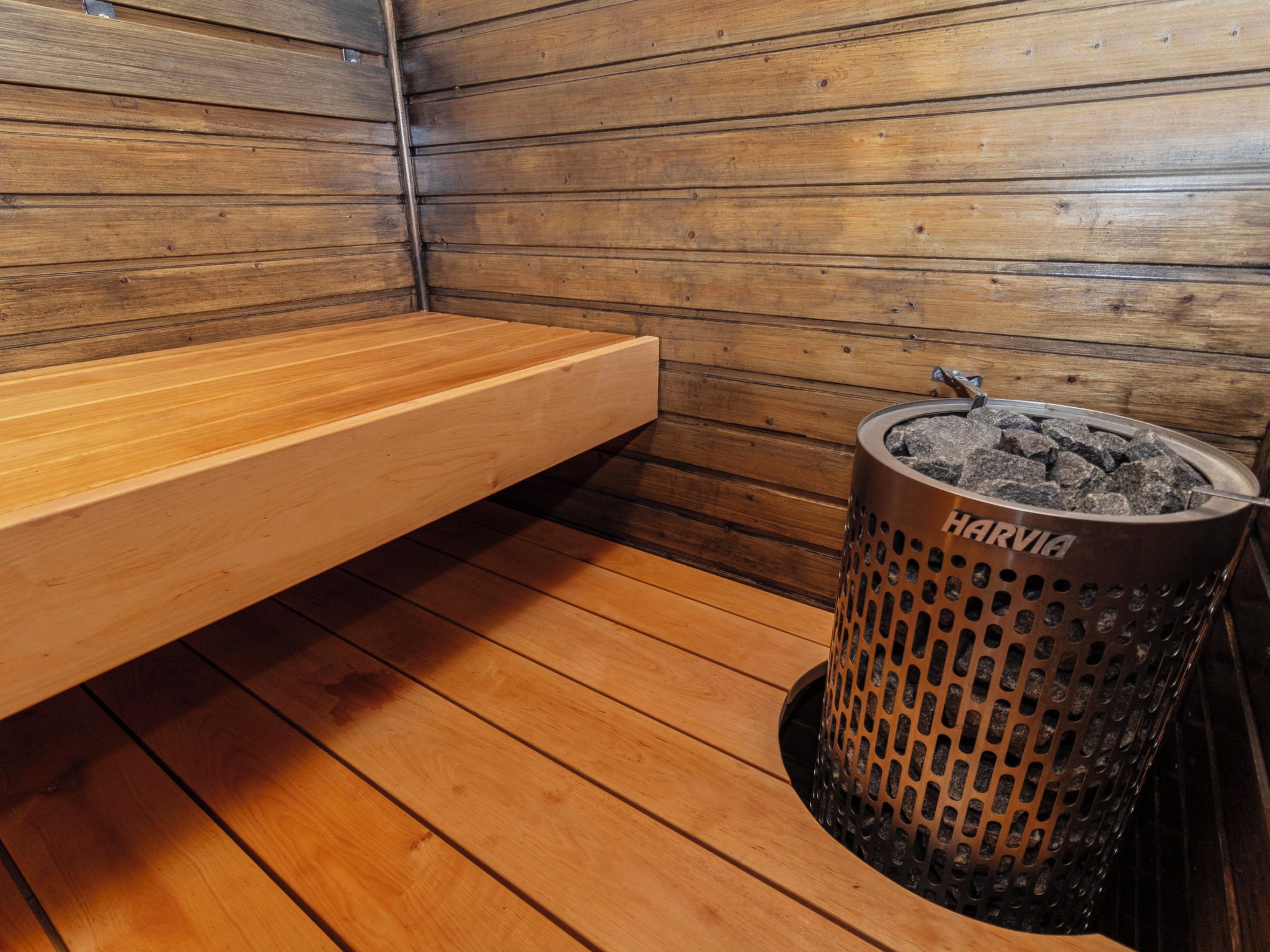 A sauna room with wooden benches and a charcoal filter.