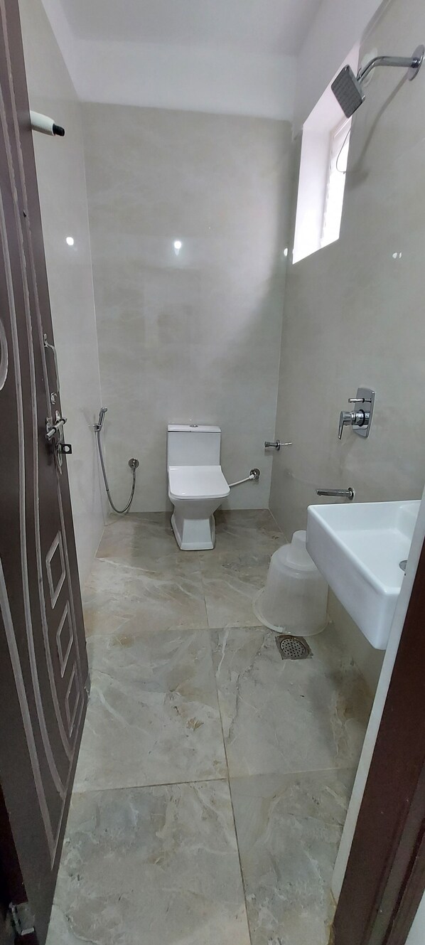 A bathroom with a toilet, shower, and sink. - Golden Premier Hotel near SR Nagar (Hyderabad)