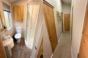 A bathroom with a toilet, sink, and shower. - Meadows 33 Hot tub - Southview Holiday Park (Skegness)