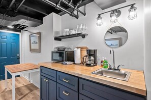 Fridge, microwave, coffee/tea maker, cookware/dishes/utensils