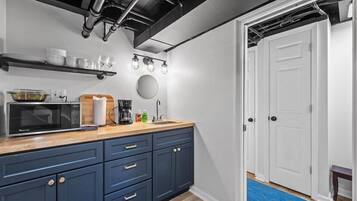 Fridge, microwave, coffee/tea maker, cookware/dishes/utensils