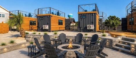 A patio area with outdoor seating and a fire pit.