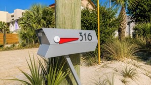 A mailbox with the number 316, surrounded by greenery and a clear sky. - Tiny Home on the Boardwalk | Walk to the Beach (Fort Walton Beach)