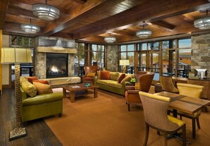 Relax in a cozy lounge area with a fireplace, comfortable seating options, and scenic views.