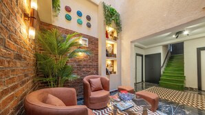 A cozy lounge area with leather armchairs, a glass coffee table, and a patterned rug. - Hexa Apartments Sisli  (Istanbul)
