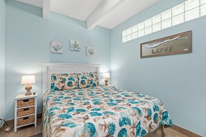 Relax in this serene bedroom with a comfortable bed, bedside tables, and a large window offering a view of the outside.