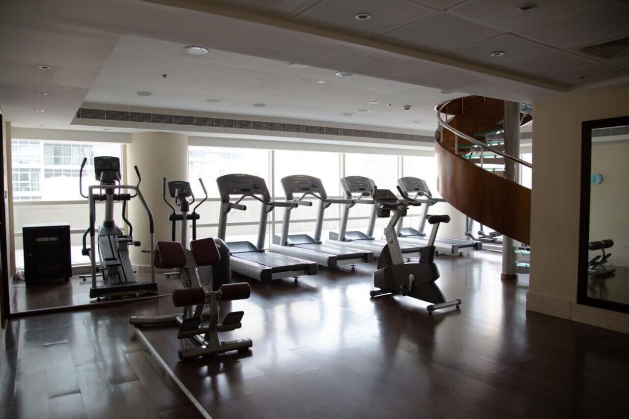 A gym with treadmills, elliptical machines, and weight equipment.