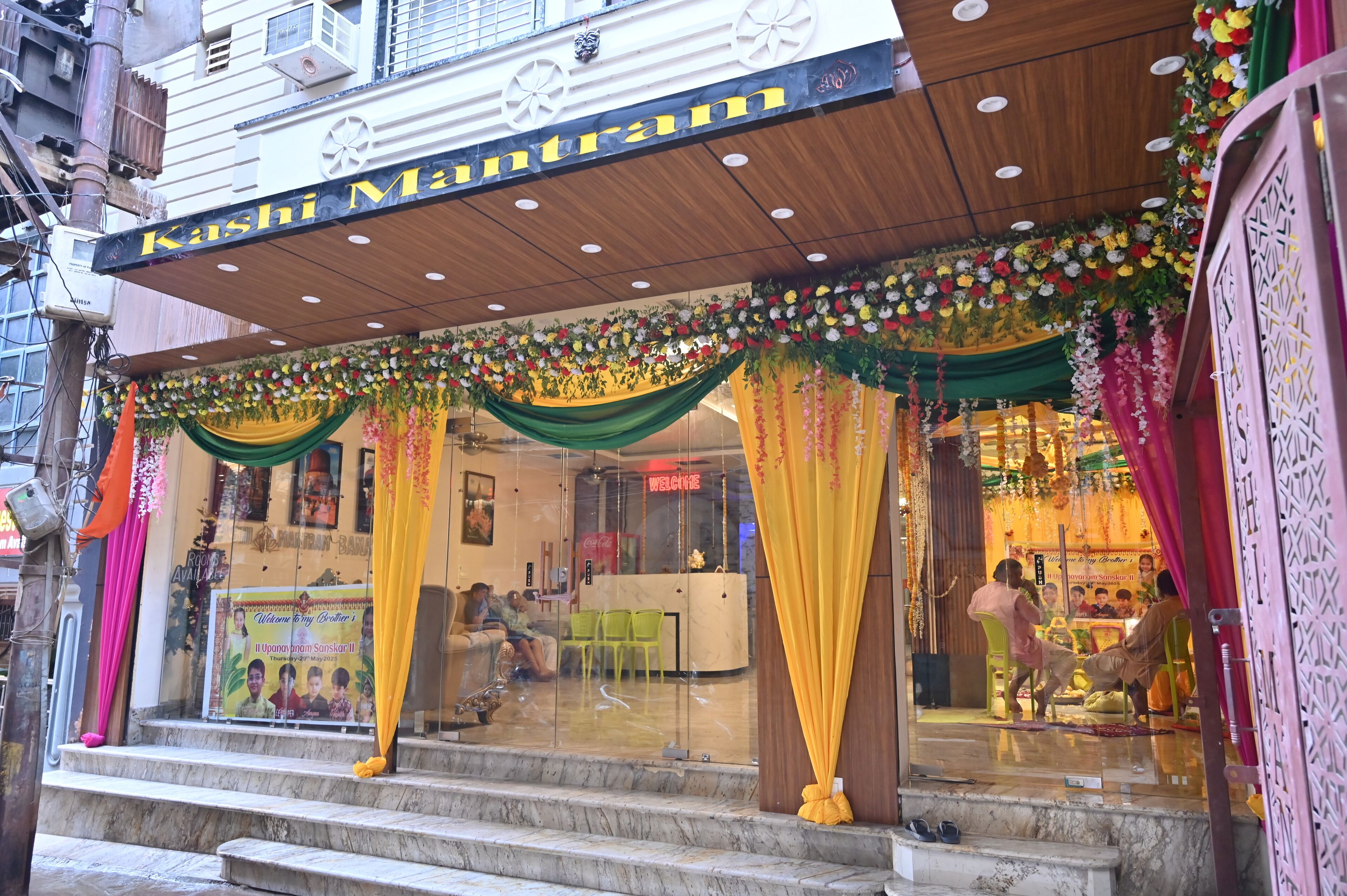 A hotel entrance with a sign reading "Kashi Mantram".