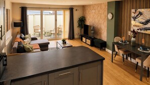 Una sala de estar moderna con un sofá, una mesa de comedor y un televisor.