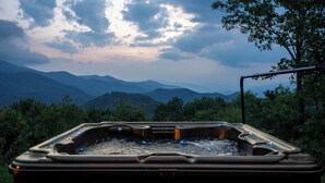 Un jacuzzi con vistas a montañas y árboles.
