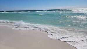 A beach with clear turquoise water and a sandy shore. - Miramar Beach 2BR • Beach + Free Beach Setup & Fun (Miramar Beach)