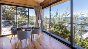 A modern room with large windows, a round table, and four chairs.