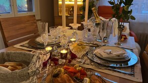 A dining table set with candles, glassware, and a basket of bread. - Engel Ingold Lodge-Romantic place in the middle of the Swiss Alps-Hotel Services (Habkern)