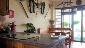 A kitchen with a fire extinguisher, a fire hose, and a fire alarm on the wall. - Casa Jienense in the Sea of Olives (Pet Friendly) (Campillo del Río)