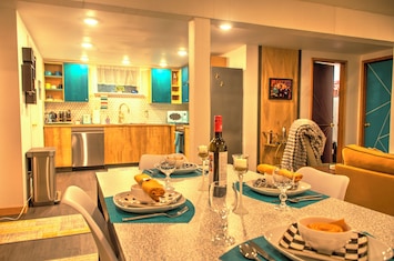 Open concept living, dining and kitchen area with dimmable lights.