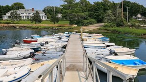 A wooden dock with several small boats docked on both sides. - 2 bedroom house in W Falmouth, Directly on Shining bike path, bike 2 beach. (Falmouth)