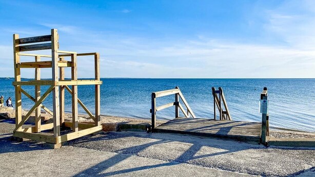 A wooden pier leading to a beach with a clear view of the sea. - 2 bedroom house in W Falmouth, Directly on Shining bike path, bike 2 beach. (Falmouth)