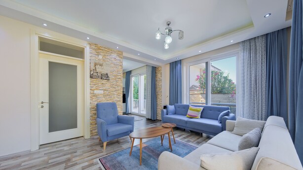 A modern living room with a sofa, armchairs, and a coffee table. - Villa Maya (Fethiye)