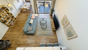 A spacious living area with a sofa, coffee table, and a dining table set for four. - Nature Views Washer, Dryer, Balcony 1 Purg #6 (Vernon)