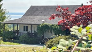 A house with a sloped roof, a covered porch, and a satellite dish.