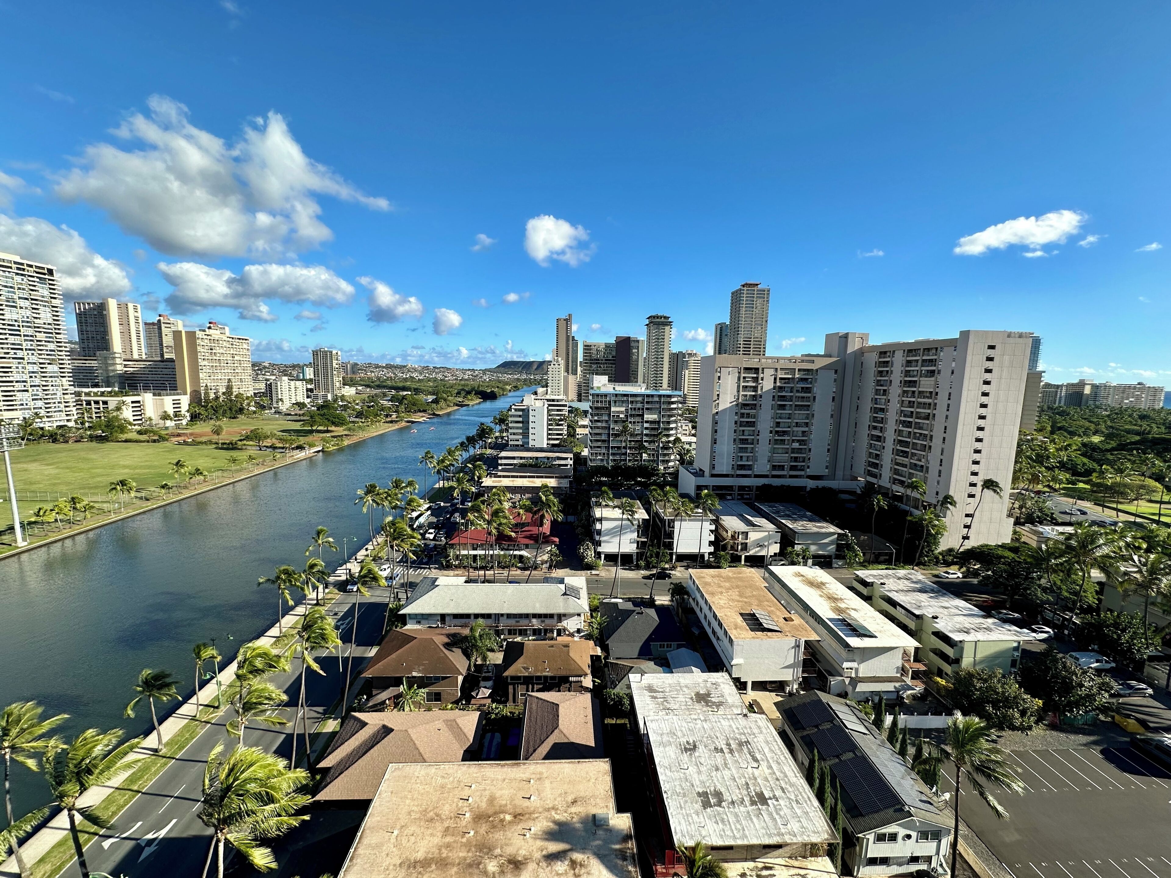 A river running through a city with high-rise buildings and a park on one side.