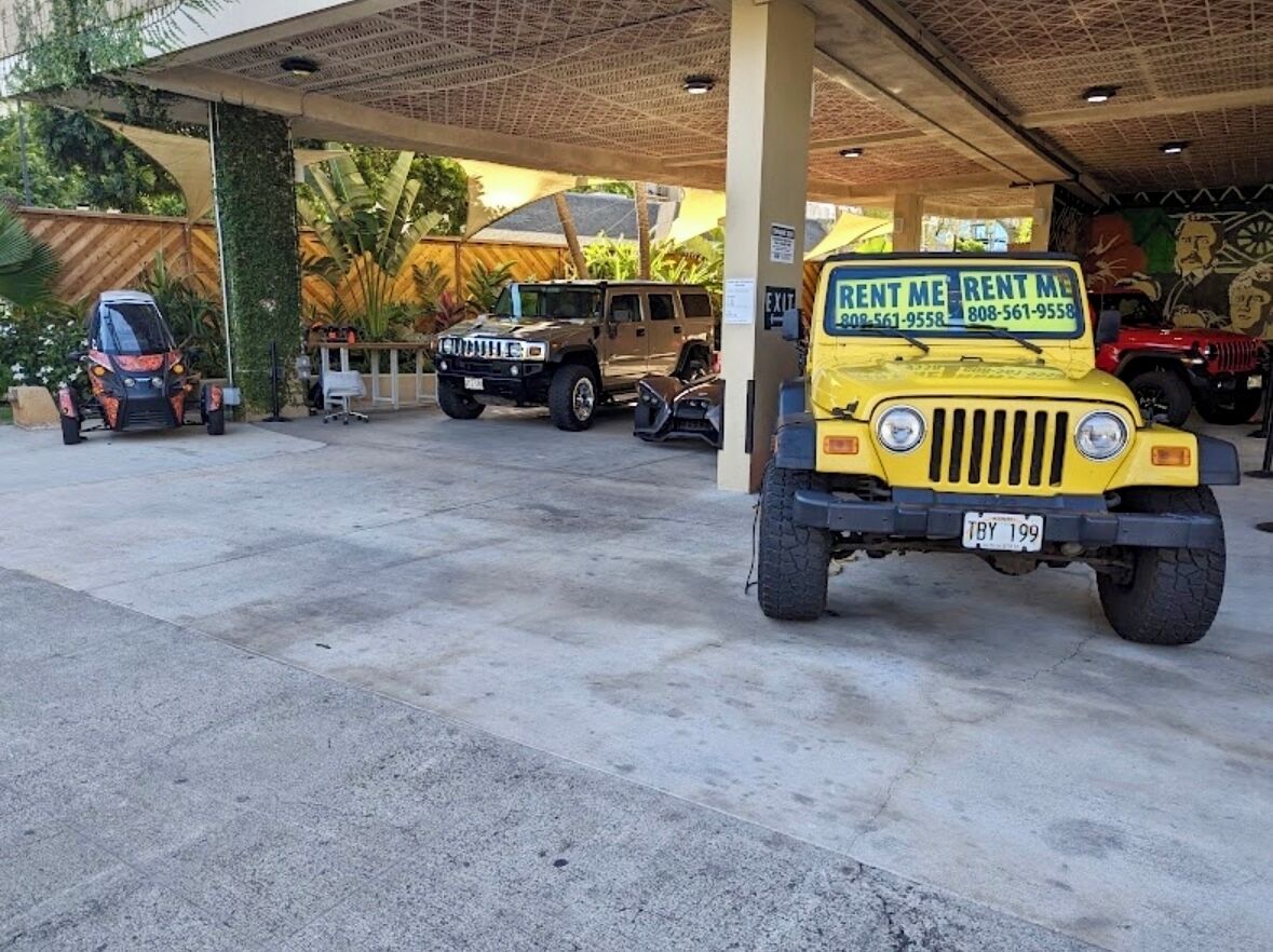 Rental cars to the left of parking garage entrance