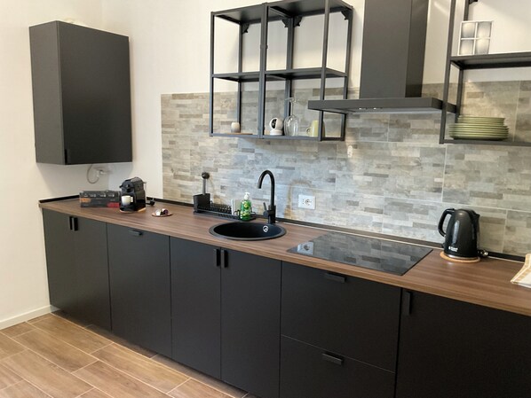 Fridge, stovetop, dishwasher, coffee/tea maker