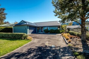 A single-story house with a garage, a front porch, and a driveway.