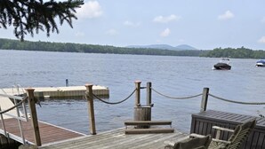 A wooden deck with outdoor seating, a dock, and a lake view. - Peaceful Green Lake Get-A-Way (Ellsworth)