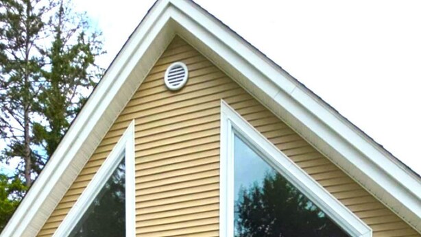 A two-story house with a gable roof, a front porch, and a small deck. - Peaceful Green Lake Get-A-Way (Ellsworth)