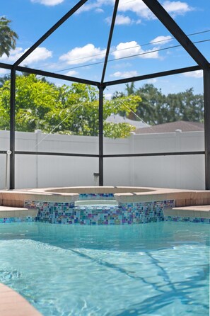 Outdoor pool, a heated pool - Fully Updated 4BR Home w/ Screened Pool & Spa (Naples)