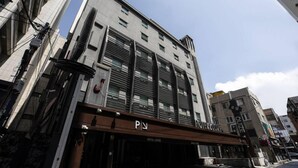 A hotel with a modern facade, multiple windows, and a sign indicating it is a hotel. - Hotel Louize (Seoul)
