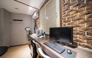 A compact office space with a desk, computer, and various office supplies.