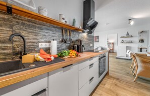 Fridge, stovetop, dishwasher, coffee/tea maker