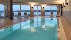 An indoor swimming pool with clear views of the waterfront through large windows. - Pet friendly apartment in Kappeln (Kappeln)