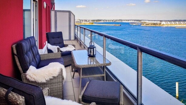 A balcony with wicker furniture, a table, and a lantern. - Pet friendly apartment in Kappeln (Kappeln)