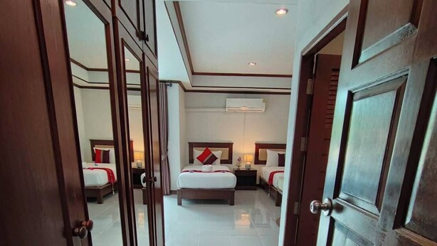A hotel room with a large bed, a smaller bed, and a desk. - Samui Grand mansion (Koh Samui)