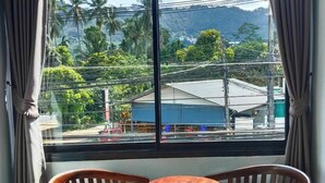 A room with a large window, two wooden chairs, and a small round table. - Samui Grand mansion (Koh Samui)