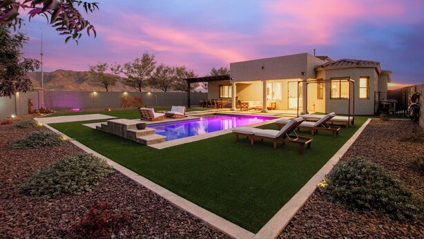 A modern house with a swimming pool, outdoor seating, and a well-maintained lawn. - Modern South Mountain Heated Pool Trails Fire Pit (Phoenix)