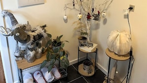 A home interior with a decorative tree, a plush toy, and a shoe rack. - 5 Person Holiday Home in Saeby (Sæby)