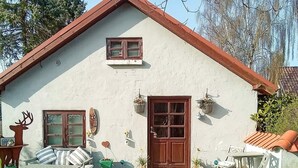 A house with a brown door, a window with shutters, and a small porch area. - 5 Person Holiday Home in Saeby (Sæby)